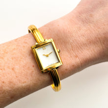 Load image into Gallery viewer, Vintage 90s Yves Saint Laurent Ladies&#39; Bangle Style Quartz Watch with Gold-Tone Bracelet and White Mother of Pearl Dial
