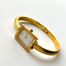 Load image into Gallery viewer, Vintage 90s Yves Saint Laurent Ladies&#39; Bangle Style Quartz Watch with Gold-Tone Bracelet and White Mother of Pearl Dial
