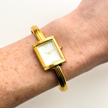 Load image into Gallery viewer, Vintage 90s Yves Saint Laurent Ladies&#39; Bangle Style Quartz Watch with Gold-Tone Bracelet and White Mother of Pearl Dial
