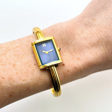 Load image into Gallery viewer, Vintage 90s Yves Saint Laurent Ladies&#39; Bangle Style Quartz Watch with Gold-Tone Bracelet and Metallic Blue Dial
