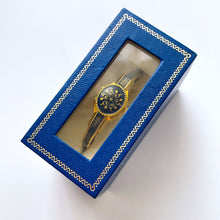 Load image into Gallery viewer, Vintage André Mouche Quartz Watch with Gold and Navy Enamel Floral Design, Concealead Dial and Gold-Plated Bangle Bracelet
