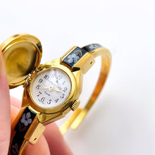 Load image into Gallery viewer, Vintage André Mouche Quartz Watch with Black Enamel Floral Design, Concealead Dial and Gold-Plated Bangle Bracelet
