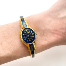 Load image into Gallery viewer, Vintage André Mouche Quartz Watch with Gold and Navy Enamel Floral Design, Concealead Dial and Gold-Plated Bangle Bracelet
