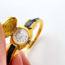 Load image into Gallery viewer, Vintage André Mouche Quartz Watch with Gold and Navy Enamel Floral Design, Concealead Dial and Gold-Plated Bangle Bracelet
