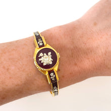 Load image into Gallery viewer, Vintage André Mouche Quartz Watch with Burgundy Enamel Floral Design, Concealead Dial and Gold-Plated Bangle Bracelet
