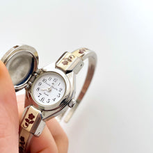 Load image into Gallery viewer, Vintage André Mouche Quartz Watch with Burgundy Enamel Floral Design, Concealed Dial and Silver-Tone Bangle Bracelet
