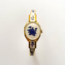 Load image into Gallery viewer, Vintage André Mouche Quartz Watch with Beige and Blue Enamel Floral Design, Concealed Dial and Gold-Plated Bangle Bracelet
