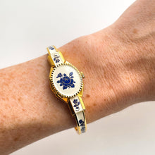 Load image into Gallery viewer, Vintage André Mouche Quartz Watch with Beige and Blue Enamel Floral Design, Concealed Dial and Gold-Plated Bangle Bracelet
