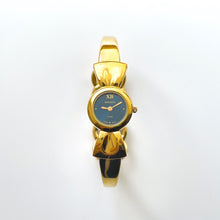 Load image into Gallery viewer, Vintage 1990s Gold-Plated Ladies&#39; Nina Ricci Bangle Quartz Watch with Ribbon Design and Small Blue Dial
