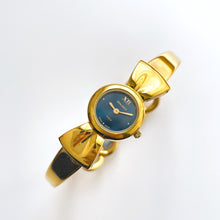 Load image into Gallery viewer, Vintage 1990s Gold-Plated Ladies&#39; Nina Ricci Bangle Quartz Watch with Ribbon Design and Small Blue Dial
