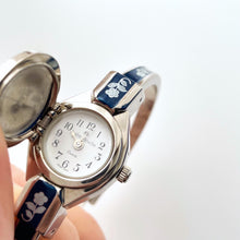 Load image into Gallery viewer, Vintage André Mouche Quartz Watch with Navy Enamel Floral Design, Concealed Dial and Silver-Tone Bangle Bracelet
