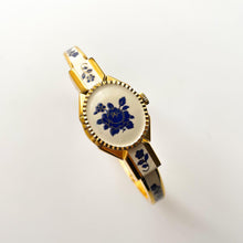 Load image into Gallery viewer, Vintage André Mouche Quartz Watch with Beige and Blue Enamel Floral Design, Concealed Dial and Gold-Plated Bangle Bracelet
