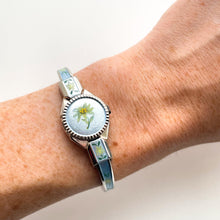 Load image into Gallery viewer, Vintage 1998 André Mouche Quartz Watch with Light Blue Enamel Floral Design, Concealed Dial and Silver-Tone Bangle Bracelet
