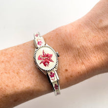 Load image into Gallery viewer, Vintage 1999 André Mouche Quartz Watch with Pink Enamel Floral Design, Concealed Dial and Silver-Tone Bangle Bracelet
