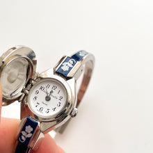 Load image into Gallery viewer, Vintage André Mouche Quartz Watch with Navy Enamel Floral Design, Concealed Dial and Silver-Tone Bangle Bracelet
