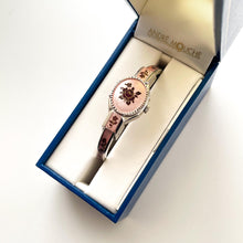 Load image into Gallery viewer, Vintage 1990s André Mouche Quartz Watch with Pink &amp; Burgundy Enamel Floral Design, Concealed Dial and Silver-Tone Bangle Bracelet
