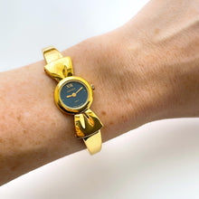 Load image into Gallery viewer, Vintage 1990s Gold-Plated Ladies&#39; Nina Ricci Bangle Quartz Watch with Ribbon Design and Small Blue Dial
