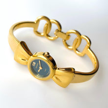 Load image into Gallery viewer, Vintage 1990s Gold-Plated Ladies&#39; Nina Ricci Bangle Quartz Watch with Ribbon Design and Small Blue Dial
