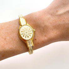 Load image into Gallery viewer, Vintage André Mouche Quartz Watch with Enamel Floral Design, Concealed Dial and Gold-Plated Bangle Bracelet
