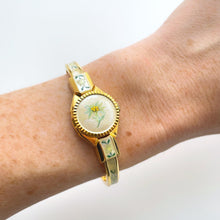 Load image into Gallery viewer, Vintage 1999 André Mouche Quartz Watch with Enamel Floral Design, Concealed Dial and Gold-Plated Bangle Bracelet
