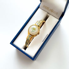 Load image into Gallery viewer, Vintage 1999 André Mouche Quartz Watch with Enamel Floral Design, Concealed Dial and Gold-Plated Bangle Bracelet
