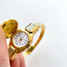 Load image into Gallery viewer, Vintage 1999 André Mouche Quartz Watch with Enamel Floral Design, Concealed Dial and Gold-Plated Bangle Bracelet
