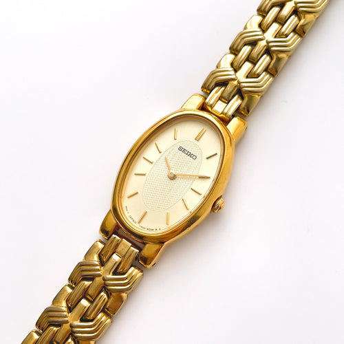 Vintage 1990s Gold-Plated Ladies' Seiko Quartz Watch with White Oval Dial and Intricate Bracelet