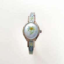 Load image into Gallery viewer, Vintage 1990s André Mouche Quartz Watch with Light Blue Enamel Floral Design, Concealed Dial and Silver-Tone Bangle Bracelet
