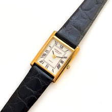 Load image into Gallery viewer, Vintage Tank-Style Gold-Plated Raymond Weil Quartz Watch with Black Leather Strap
