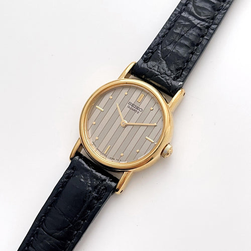 Vintage Gold-Plated Ladies' Seiko Quartz Watch with Striped Dial and Black Leather Strap