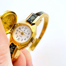 Load image into Gallery viewer, Vintage André Mouche Quartz Watch with Black and Green Enamel Floral Design, Concealed Dial and Gold-Plated Bangle Bracelet
