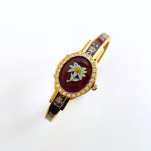 Load image into Gallery viewer, Vintage André Mouche Quartz Watch with Burgundy Enamel Floral Design, Concealead Dial and Gold-Plated Bangle Bracelet
