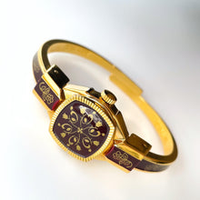 Load image into Gallery viewer, Vintage André Mouche Quartz Watch with Burgundy Enamel Floral Design, Concealead Dial and Gold-Plated Bangle Bracelet
