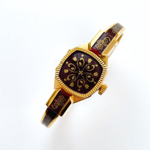 Load image into Gallery viewer, Vintage André Mouche Quartz Watch with Burgundy Enamel Floral Design, Concealead Dial and Gold-Plated Bangle Bracelet
