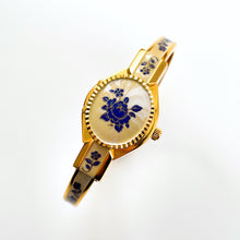 Load image into Gallery viewer, Vintage 00s André Mouche Quartz Watch with Beige and Blue Enamel Floral Design, Concealed Dial and Gold-Plated Bangle Bracelet - Boxed
