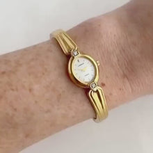 Load and play video in Gallery viewer, Very Rare 1995 Gold-Plated Lassale (Seiko) Articulated Bangle Quartz Watch with Mother of Pearl Dial and Diamond-Set Bezel
