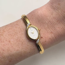 Load and play video in Gallery viewer, Very Rare 1990s Gold-Plated Lassale (Seiko) Articulated Bangle Quartz Watch with Mother of Pearl Dial and Diamond-Set Bezel
