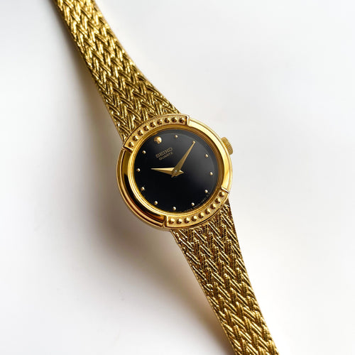 1990s Ladies' Gold-Tone Seiko Quartz Watch with Black Round Dial