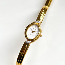 Load image into Gallery viewer, Very Rare 1990s Gold-Plated Lassale (Seiko) Articulated Bangle Quartz Watch with Mother of Pearl Dial and Diamond-Set Bezel
